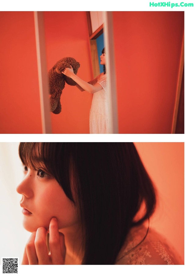 A woman holding a teddy bear in front of a mirror.
