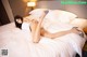 A woman laying on top of a bed in a hotel room.