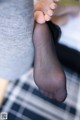 A close up of a woman's feet in black stockings.